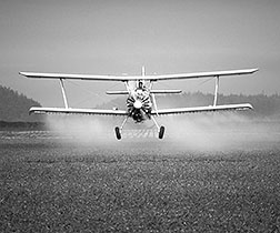 Report cover image of a propeller plane crop dusting a field