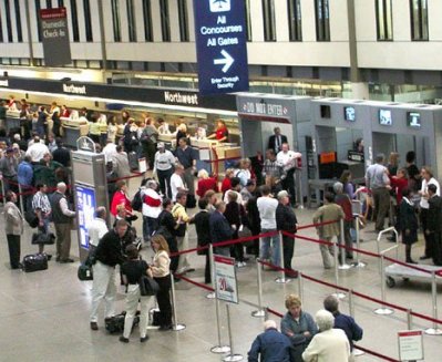 Image of passengers going through security check point at airport