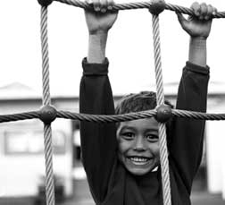 image of of boy swinging on ropes