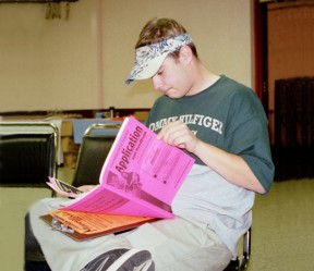 Image, unemployment insurance applicant reviewing application materials