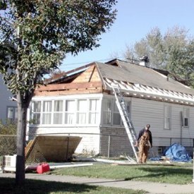 Image of older house being re-shingled